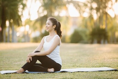 woman on a yoga mat to relax outdoor