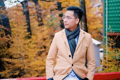 portrait of asian male tourist traveler  wearing a suit in tokyo japan. 