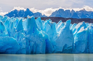 the grey glacier by grey lake with the andes mountain range, torres del paine national park, patagonia, chile.