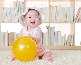 cute baby girl playing with ball