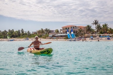 elder fit man is kayaking on a bright yellow kayak in caribbean sea during a sunny summer day. taken in varadero, cuba.