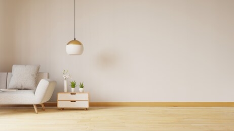 empty living room with blue fabric sofa ,lamp and plants on empty white wall background.3d rendering
