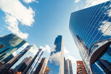 modern tower buildings or skyscrapers in financial district with cloud on sunny day in chicago, usa. construction industry, business enterprise organization, or communication technology concept