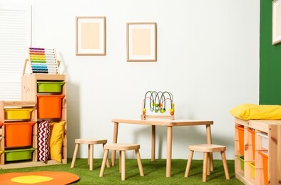 stylish playroom interior with table and stools
