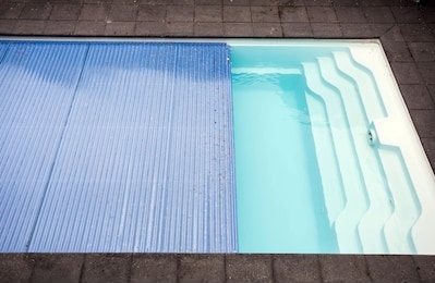 swimming pool cover detail for protection and heat the water, pool roller-shutter covers close-up