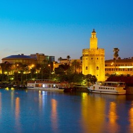 cityscape with river of seville at night, spain