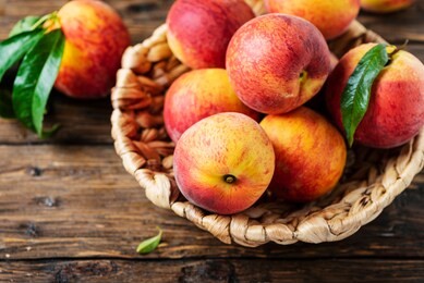 fresh sweet peaches on the wooden table, selective focus
