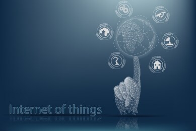 internet of things (iot). the concept of managing things via the internet. the human hand holds the globe on its finger.