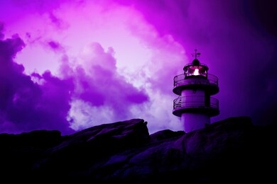 neon colored landscape with working lighthouse and bad weather cloudscape. purple color backdrop