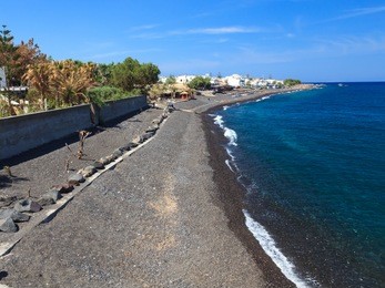 the black volcanic beach at kamari santorini greece