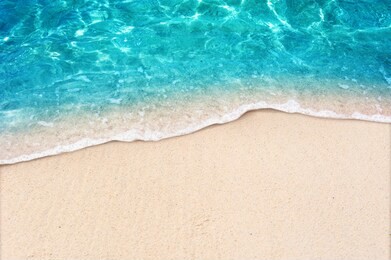 soft blue ocean wave on clean sandy beach