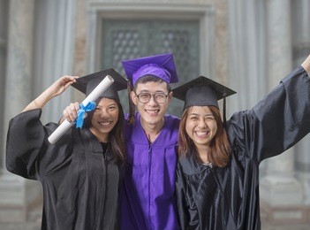 three friends celebrating graduation