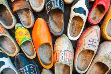 set of different colorful vintage dutch wooden clogs