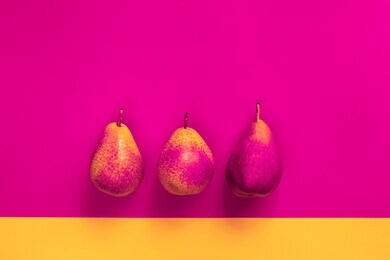 yellow-pink pears on a colored background. vitamins, organic products, autumn harvest, vegetarianism, energy and juicy. fantasy postcard for decor, flat lay, copy space, vibrance neon fine art.