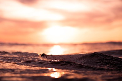 this was a macro photo of a ripple in the water during sunset.
