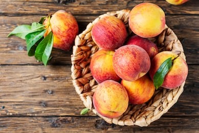 summer concept. fresh sweet peaches on the wooden table, selective focus