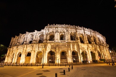 night time view of  place des arenes, nimes france