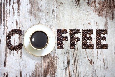 cup of coffee with letters beans on vintage retro boards