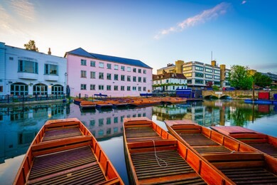 punts on the river cam at the city center of cambridge, england