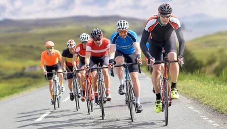cyclists out racing along country lanes near the coast in the united kingdom