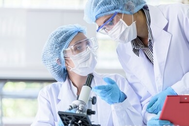 asian scientist team has researching in laboratory.