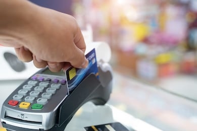 hand swiping credit card in store