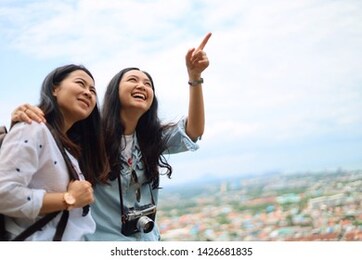 two young asian woman traveling together in long vacation.