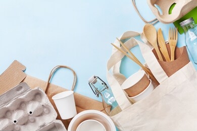 plastic free set with cotton bag, glass jar and recycled tableware top view. zero waste, eco friendly concept.