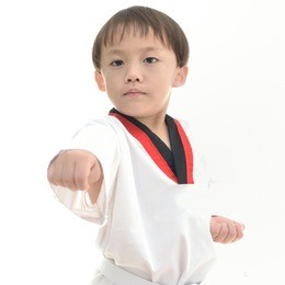 cute asian boy with taekwondo uniform on white background.