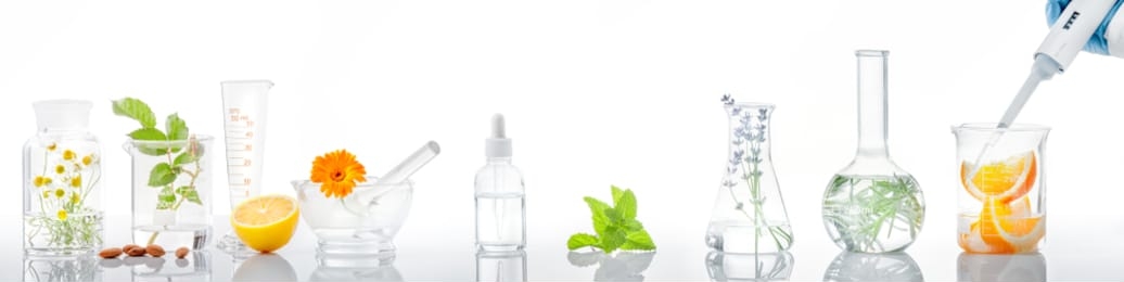 scientific experiment.herbs,flower and orange  in test tubes