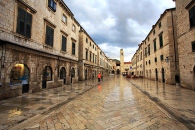 worker collecting rubbish at dawn in dubrovnik