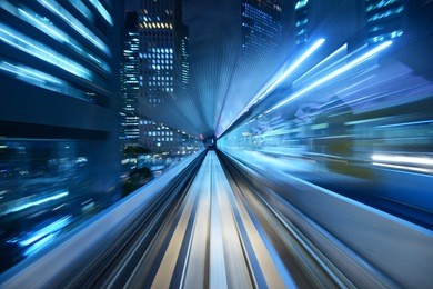motion blur of a city and tunnel from inside a moving monorail in tokyo.