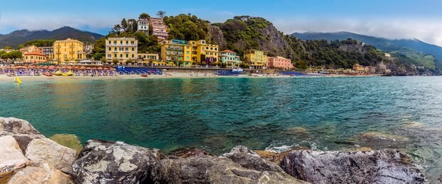a panorama view from the sea wall towards the beach at monterosso al mare, italy in summer
