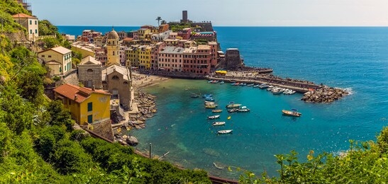 a view over the picturesque village and harbour of vernazza in summertime