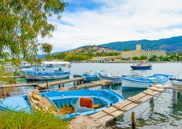 wooden pier with fishing boats at poros island in greece