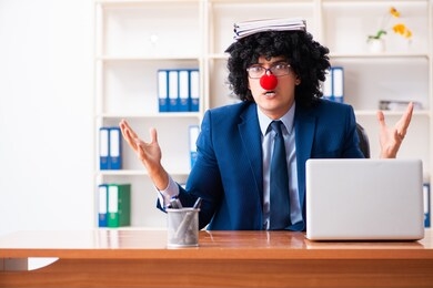 young clown businessman working in the office 