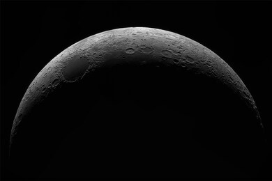 crescent young moon with a large increase. moon, view through a telescope. moon with craters.