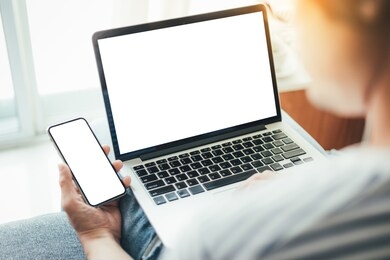 mockup image blank screen computer,cell phone with space for advertising text,hand using laptop texting mobile contact business searching information in workplace desk in office.design creative work