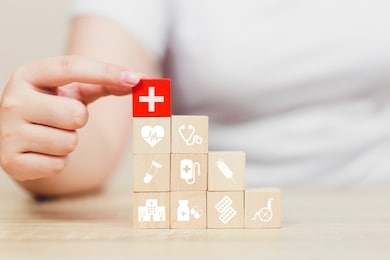 health insurance concept,hand arranging wood block stacking with icon healthcare medical.