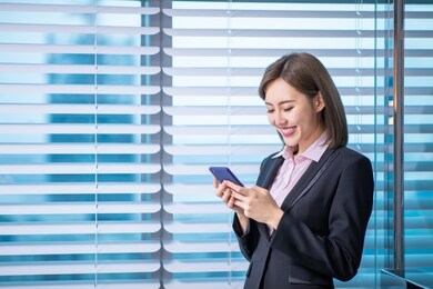 young asian business woman use smart phone in the office