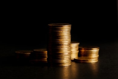 stack of gold coin on black background.