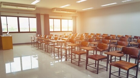 empty university classroom with wooden chairs and desks. modern university lecture room without student. 