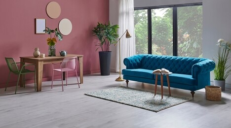 modern living room blue sofa armchair, dinning table wooden and metal green chair.