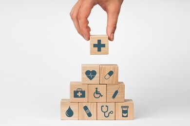 concept of insurance for your health, hand hold wooden block with icon healthcare medical