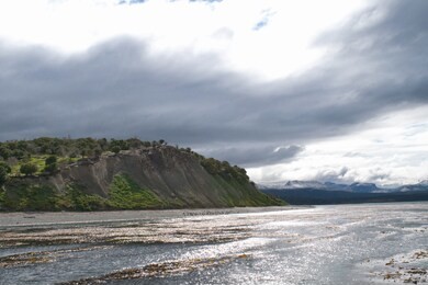 dark clouds over the island in the beagle channel, tierra del fuego, argentina