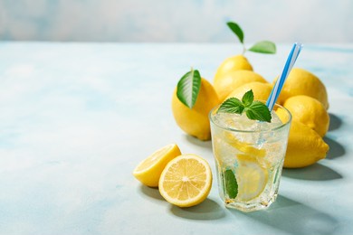 lemon and fresh mint in glasses on light  background. cold refreshing lemonade for summer party and fun.