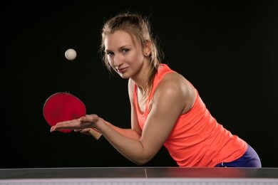young beautiful athletic girl playing ping pong