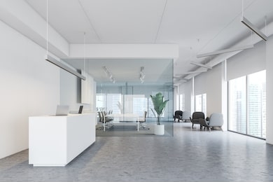 interior of modern office with white walls, concrete floor, white reception table, meeting room with glass walls and lounge with armchairs. 3d rendering