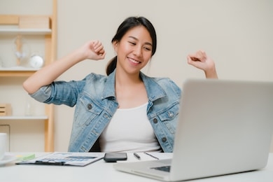 business freelance woman stretching her body because feel tired after working on laptop, smart female working at home. lifestyle women relax after working at home concept.