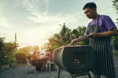 bbq party group of people at barbecue dinner friends having food together outdoor as summer with friendship asian person.